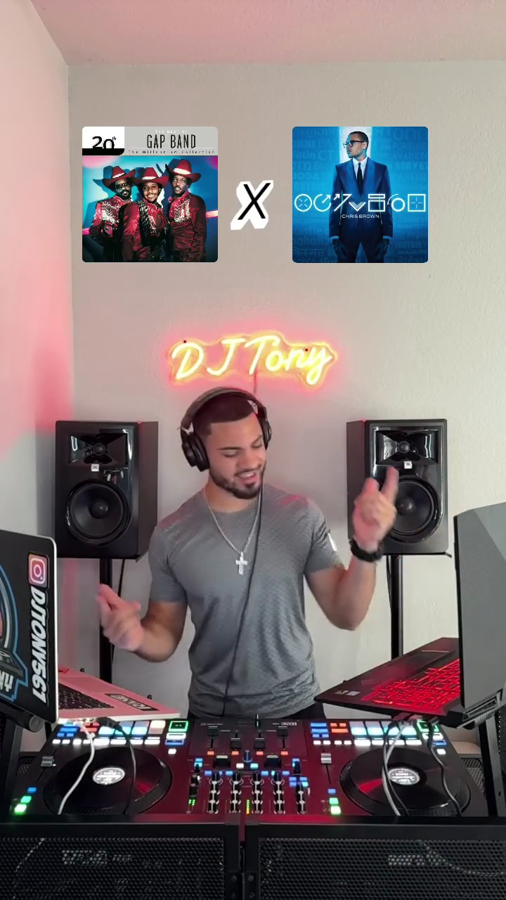 DJ Tony vibing in home studio with neon sign and decks